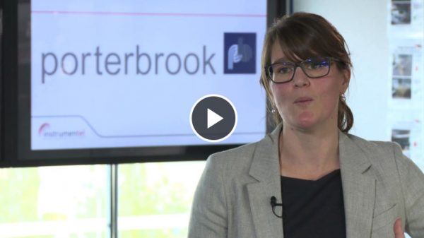 A women being interviewed in an office in front of a Porterbrook logo