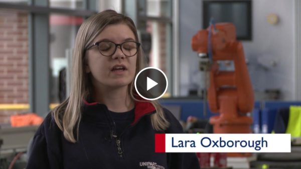 Woman in Unipart fleece being interviewed in a manufacturing facility