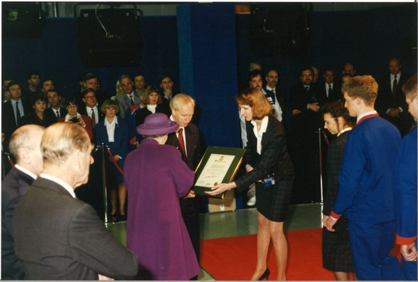 The Queen receives a certificate from John Neill at Unipart in March 1995 as HRH Duke of Edinburgh looks on